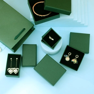 Elegant dark green jewelry gift box set with matching paper bag and gold accessories