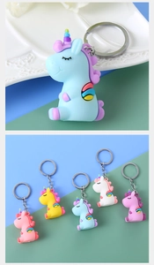 Close-up of cute 3D unicorn PVC keychains in various soft pastel colors for bags