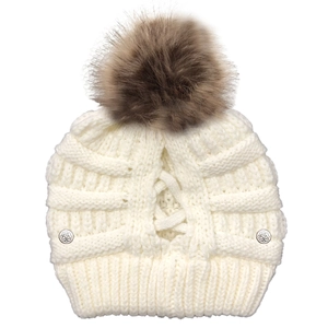 Detail of white knit beanie featuring crisscross ponytail hole and rose buttons