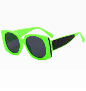 Detail of neon green oversized sunglasses featuring a black textured scale pattern temple