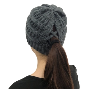 Detail of cross-opening at back of dark grey knitted ponytail beanie for long hair
