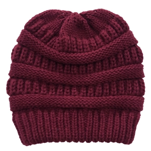 Close-up of burgundy chunky knit wool beanie showing thick texture and warm weave