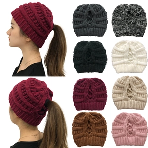 Detail view of ponytail knit beanie showing top opening in multiple color options