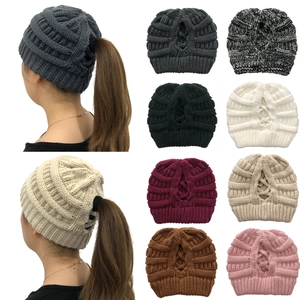 Detail showing the ponytail hole design and warm knit texture of the beanie hat