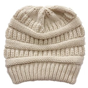 Close-up of thick textured knit pattern on beige winter hat with crossover detail