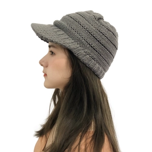 Side view of grey knitted visor beanie showing winter ear protection and warm texture