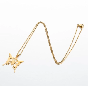 Detail of golden butterfly pendant necklace with lobster clasp on white background