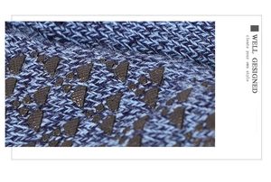 Macro shot of blue knitted fabric featuring grey anti-slip silicone grip dots detail