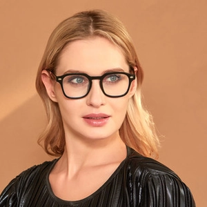 Close-up of model wearing black round rectangle glasses with blue light filter lenses