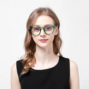 Front view of translucent green round glasses frame worn by a female model