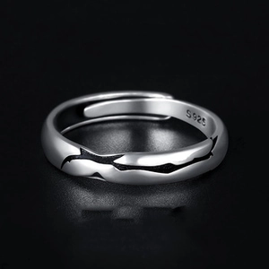 Macro shot of S925 sterling silver stamp and wave texture on adjustable open ring