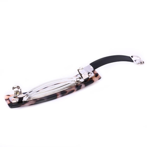 Close-up of leopard pattern acetate hair clip with silver metal spring mechanism