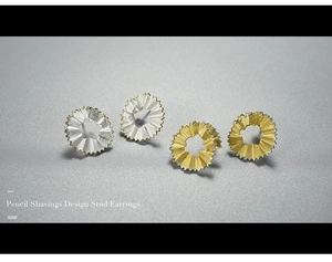 Macro shot of pencil shavings design stud earrings in gold and silver finish
