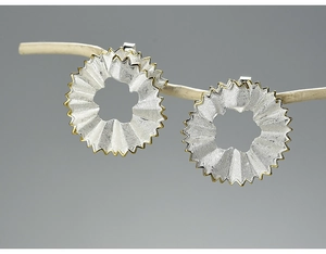 Detailed macro view of S925 silver pencil shavings earrings with elegant gold edges