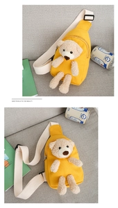 Detail view of yellow canvas kids chest bag with 3D teddy bear and beige strap