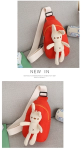 Close-up of red canvas kids chest bag featuring a 3D bunny and adjustable strap