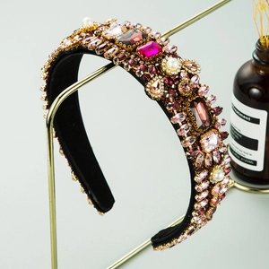 Detailed view of Baroque headband with pink rhinestones and pearls on black velvet base