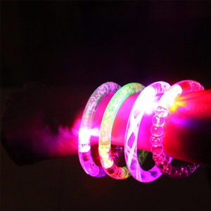 Set of four colorful LED glowing bracelets in pink, green, white, and red light