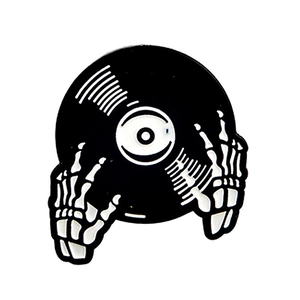 Creative enamel pin featuring a skeleton hand holding a vintage vinyl record disc
