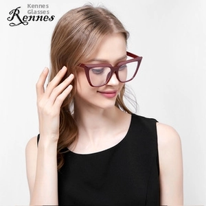 Close-up of wine red cat-eye glasses frame on a model featuring a retro metal design