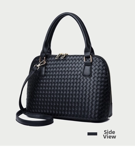 Detail of black woven shell bag with gold zippers and detachable shoulder strap