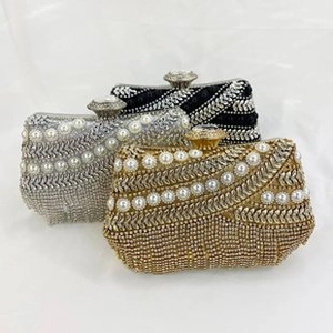 Detailed view of sequined evening clutch bags with sparkling rhinestones and faux pearls
