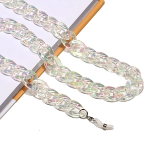 Detail of colorful acrylic glasses chain with metal hooks on a yellow notebook
