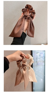 Detail of elegant satin bow hair scrunchies with long ribbons in multiple earthy colors