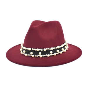 Detailed view of wine red wool fedora featuring an elegant pearl-embellished black band