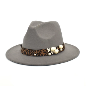 Close-up of grey felt fedora featuring a leopard print ribbon with pearls and floral detail
