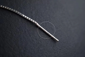 Macro view of S925 sterling silver hallmark on the elegant pearl earring chain
