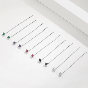 Detailed view of colorful square-cut gemstones on sterling silver long chain earrings