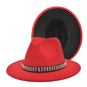 Detail of red fedora hat with silver studs on black band and contrasting black brim interior