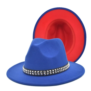 Detail of royal blue fedora hat with red brim underside and silver studded band decoration