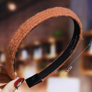 Detail shot of orange plush headband showing 15.5cm width with soft texture