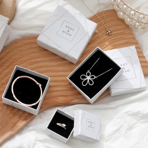 Detail of white marble pattern jewelry box with elegant gold leaf trim and best wish text