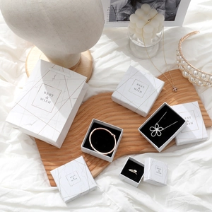 Elegant white marble jewelry box set with gold text for necklaces and rings
