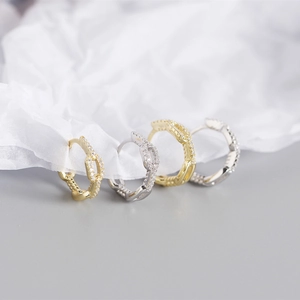 Macro shot of S925 silver chain hoop earrings with micro-paved cubic zirconia stones
