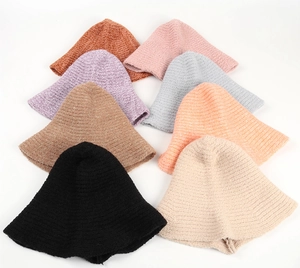 Texture detail of knitted witch bucket hats in black beige coffee and gray tones
