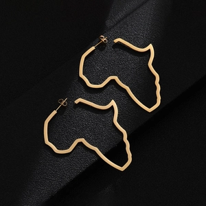 Close-up of gold stainless steel Africa map earrings with hollow-out design on black texture