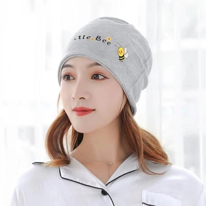 Detail of grey knitted maternity hat featuring Little Bee embroidery and cartoon motif