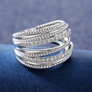 Macro shot of silver-tone multi-layer crisscross ring with zircons and twist texture