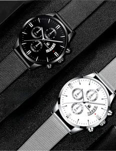 Detail of two business quartz watches with steel mesh straps and calendar display