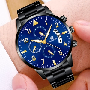 Close-up of blue quartz watch dial with three sub-dials and date window on wrist