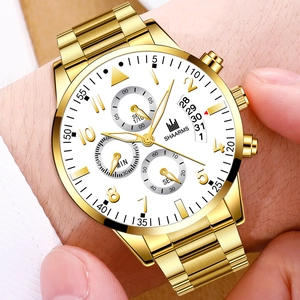 Detailed close-up of gold steel business watch with date window and white dial sub-dials