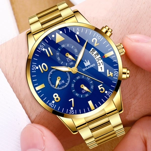 Detail of gold metal band business watch with blue dial and date display macro
