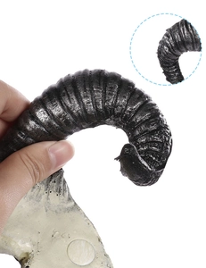 Detailed view showing the realistic texture and spiral grooves of the black 3D sheep skull mask