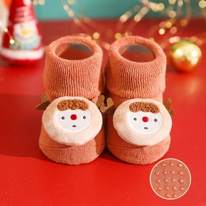 Detail view of baby winter Christmas socks with cute reindeer face and anti-slip silicone sole.