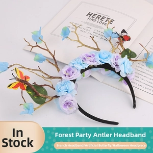 Detail view of double blue and purple fabric roses with butterflies on a forest style headband