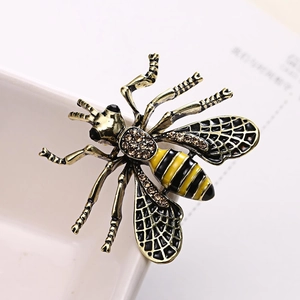 Vintage gold bee brooch featuring black and yellow enamel wings with brown rhinestones